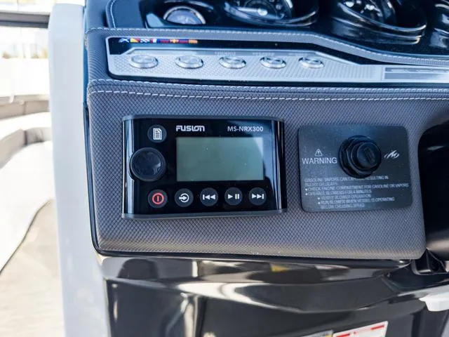 Slide: The Image of Control panel of 2024 Monterey 258 SS boat featuring Fusion MS-NRX300 stereo system. - 28