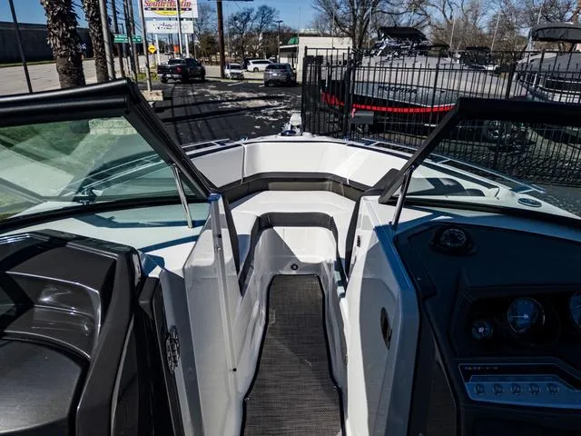 Slide: The Image of 2024 Monterey 258 SS boat interior with open bow seating and dashboard view. - 35