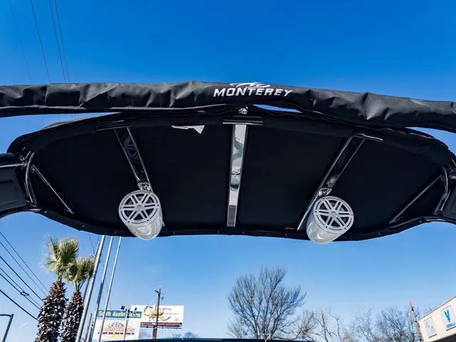 Slide: The Image of 2024 Monterey 258 SS boat canopy with speakers against a clear blue sky. - 43