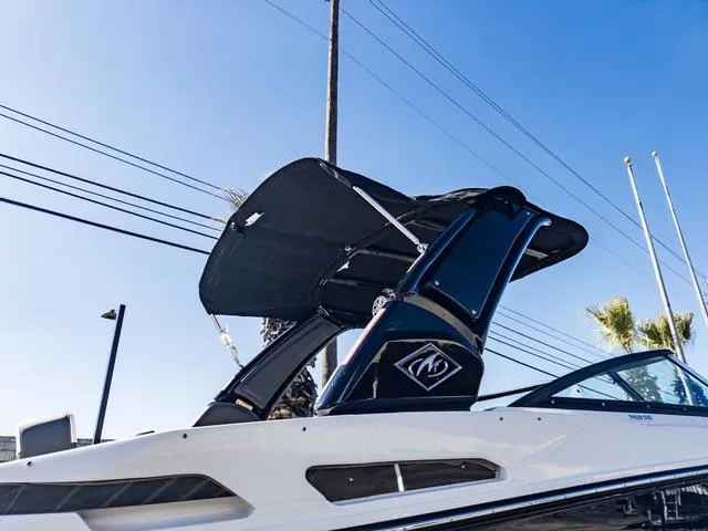 Slide: The Image of 2024 Monterey 258 SS boat with black canopy against a clear blue sky. - 44