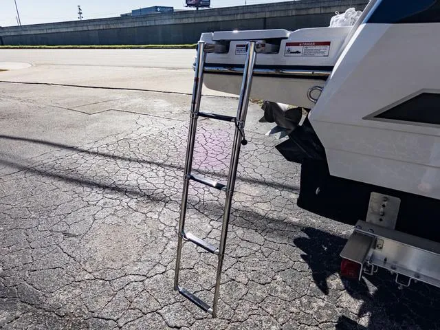Slide: The Image of 2024 Monterey 258 SS boat with extended ladder on a cracked pavement. - 45