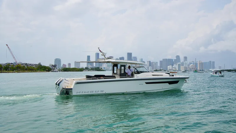 Slide: The Image of 2024 Nimbus Tender 11 #258 cruising in a city harbor. - 0