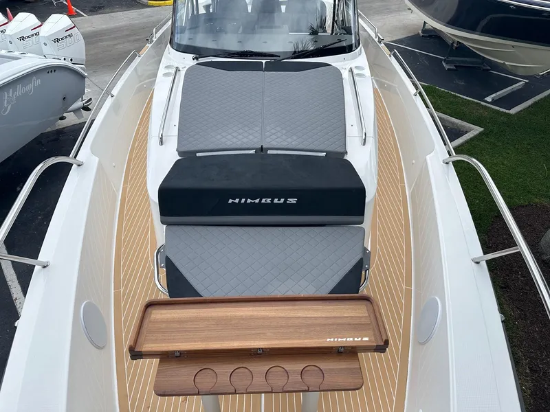 Slide: The Image of 2024 Nimbus Tender 11 #258 boat with cushioned seating and wooden table. - 15