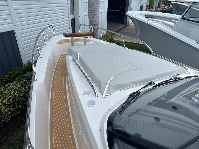 Slide: The Image of 2024 Nimbus Tender 11 #258 boat with teak deck and covered bow area. - 20