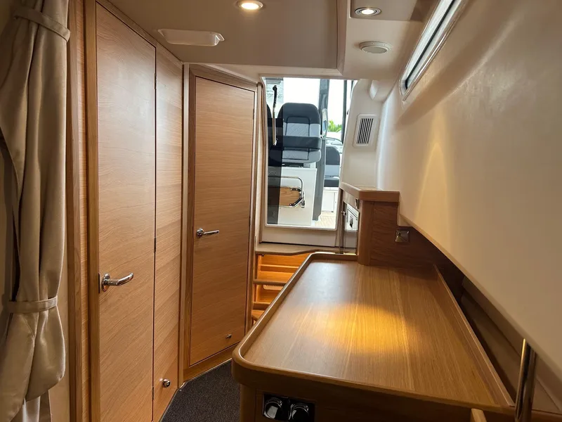 Slide: The Image of Interior cabin of 2024 Nimbus Tender 11 #258 with wooden finishes and modern design. - 21