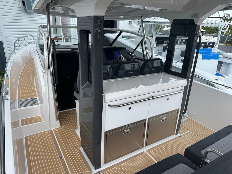 Slide: The Image of 2024 Nimbus Tender 11 #258 boat interior with modern helm and seating. - 23