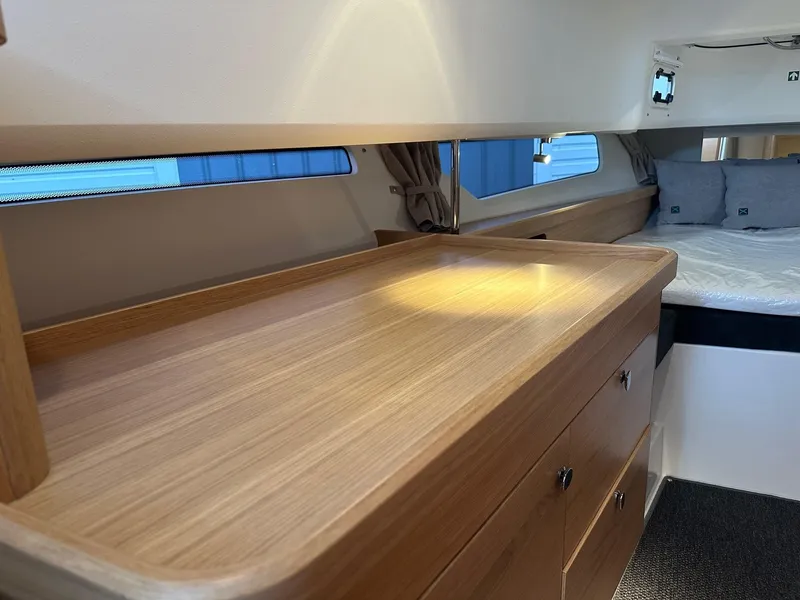 Slide: The Image of Interior of 2024 Nimbus Tender 11 #258, featuring wooden cabinetry and cozy sleeping area. - 26