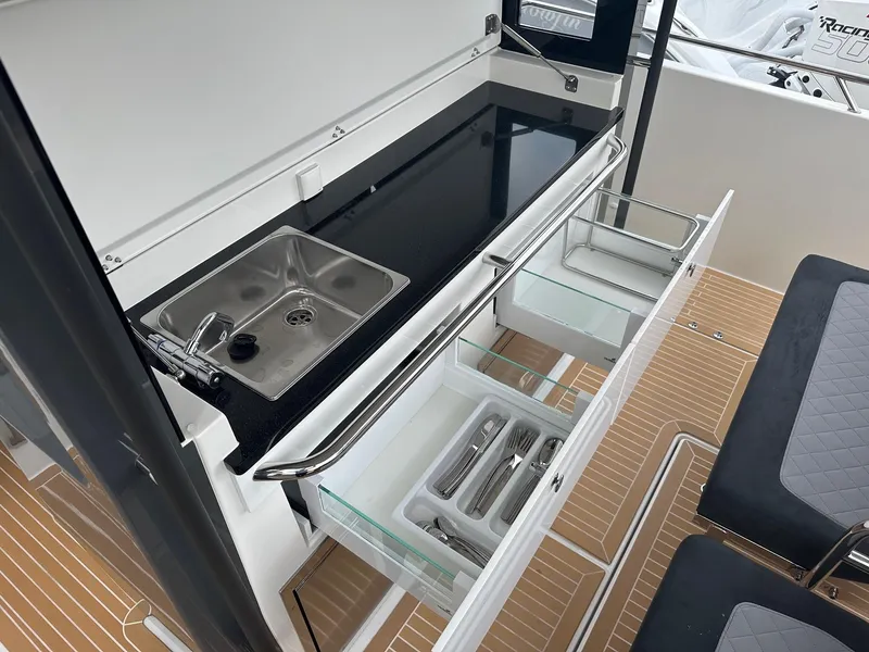 Slide: The Image of Modern kitchen area on the 2024 Nimbus Tender 11 #258 boat with sink and storage drawers. - 33