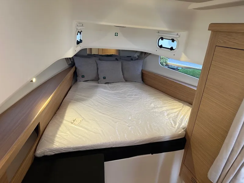 Slide: The Image of Cozy cabin bed in 2024 Nimbus Tender 11 #258 boat with wooden accents. - 38