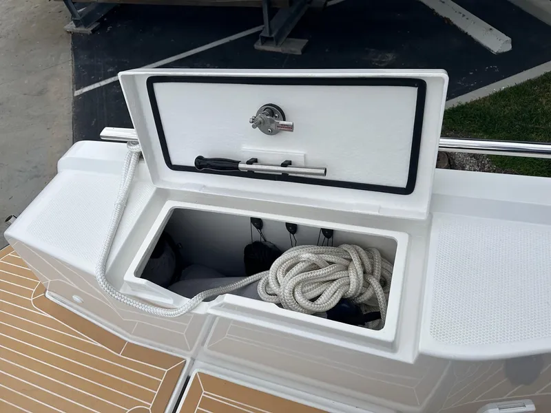 Slide: The Image of Storage compartment on a 2024 Nimbus Tender 11 #258 boat with rope and tools. - 8
