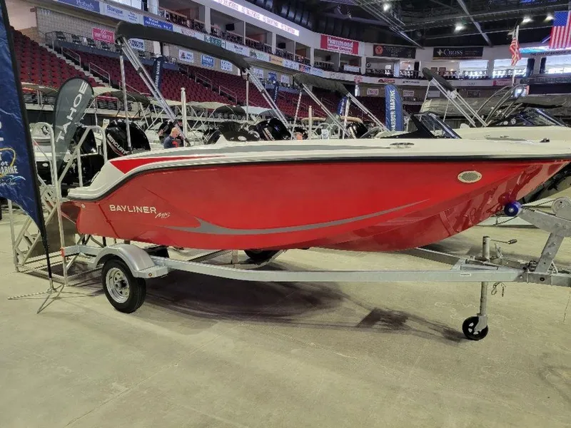 Slide: The Image of 2024 Bayliner M15 red boat on display in an indoor showroom. - 0