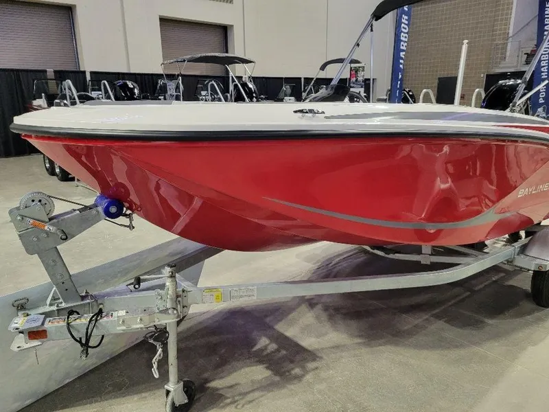 Slide: The Image of 2024 Bayliner M15 boat in red on a trailer at an indoor showroom. - 10