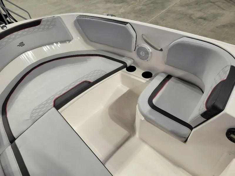 Slide: The Image of 2024 Bayliner M15 boat interior seating with cup holders and speaker. - 4