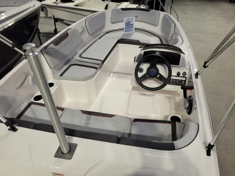 Slide: The Image of 2024 Bayliner M15 boat interior with steering wheel and seating. - 9