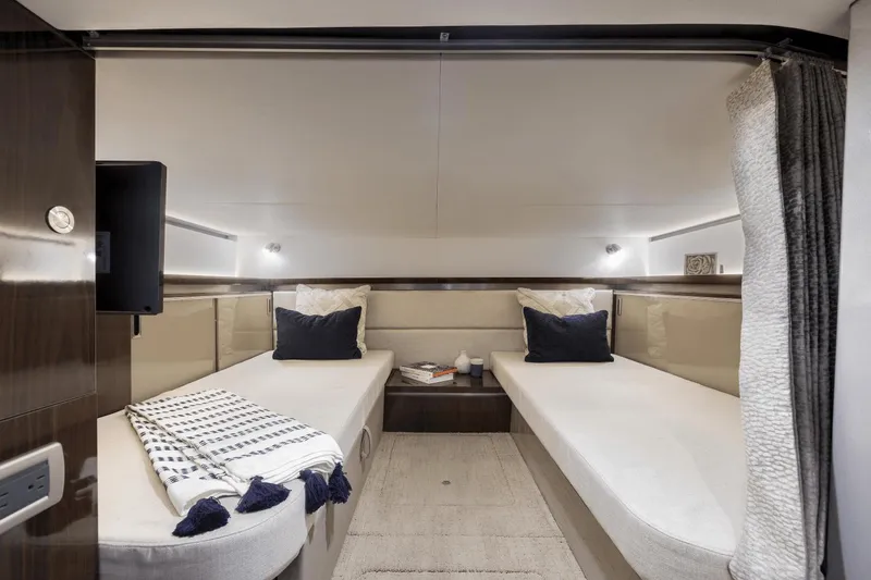 Slide: The Image of 2024 Sea Ray Sundancer 320 Outboard cabin with twin beds and modern decor. - 12