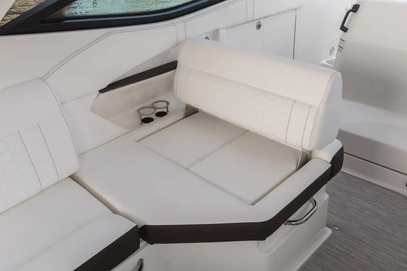 Slide: The Image of 2024 Sea Ray Sundancer 320 Outboard interior seating with cup holders and elegant design. - 4