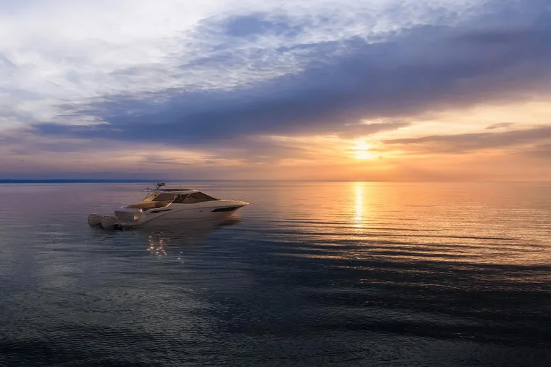 Slide: The Image of 2024 Sea Ray Sundancer 320 Outboard cruising at sunset on calm waters. - 6