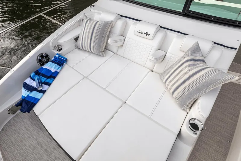 Slide: The Image of Luxurious seating on 2024 Sea Ray Sundancer 320 Outboard with striped pillows and towel. - 8