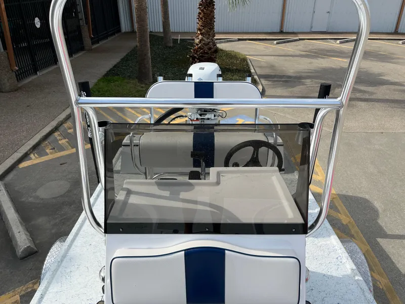 Slide: The Image of 2024 Shallow Stalker SS-17 Sportsman boat console and steering wheel in a parking lot. - 13