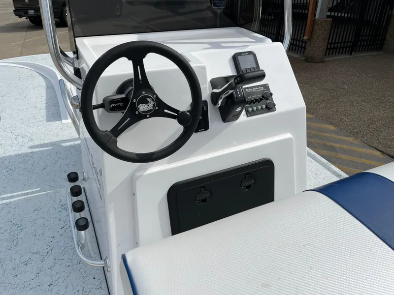 Slide: The Image of 2024 Shallow Stalker SS-17 Sportsman boat console with steering wheel and controls. - 16