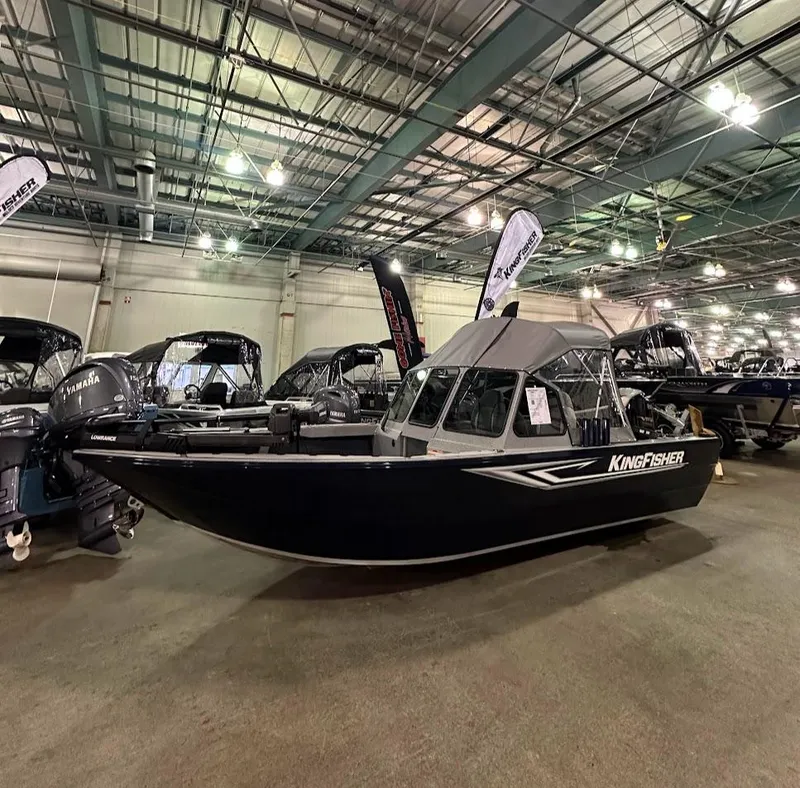 Slide: The Image of 2024 KingFisher 1825 Warrior Sport boat displayed at an indoor boat show. - 0