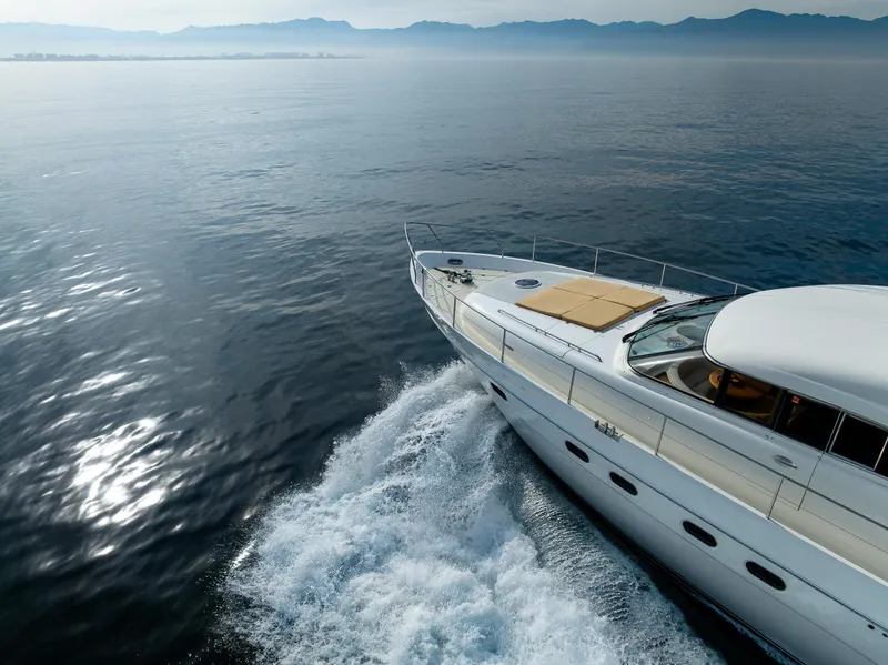 Slide: The Image of 2002 Viking Princess 72 SportCruiser yacht cruising on calm ocean waters. - 16