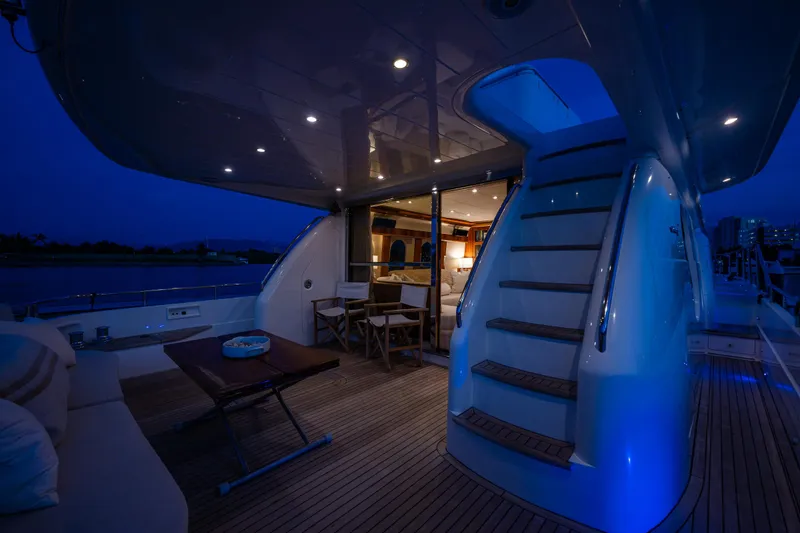 Slide: The Image of Luxurious 2002 Viking Princess 72 SportCruiser yacht deck at night with elegant lighting. - 23