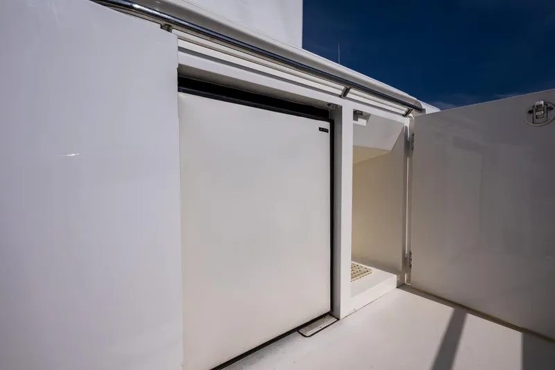 Slide: The Image of 2002 Viking Princess 72 SportCruiser yacht storage compartment with white cabinetry. - 30