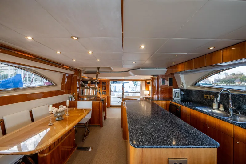 Slide: The Image of Luxurious interior of 2002 Viking Princess 72 SportCruiser yacht with modern kitchen and dining area. - 39