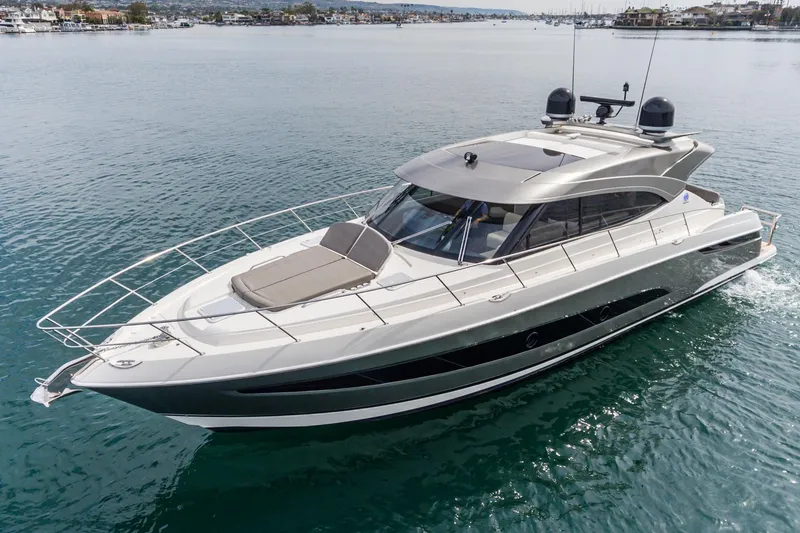 The Image of 2020 Riviera 5400 Sport Yacht cruising on calm waters, showcasing sleek design and luxury features. - 0