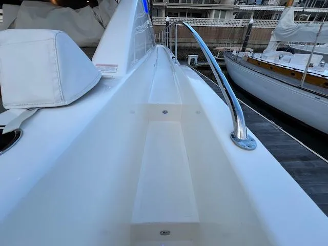 Slide: The Image of 2020 Riviera 5400 Sport Yacht deck with sleek design and chrome railing. - 11