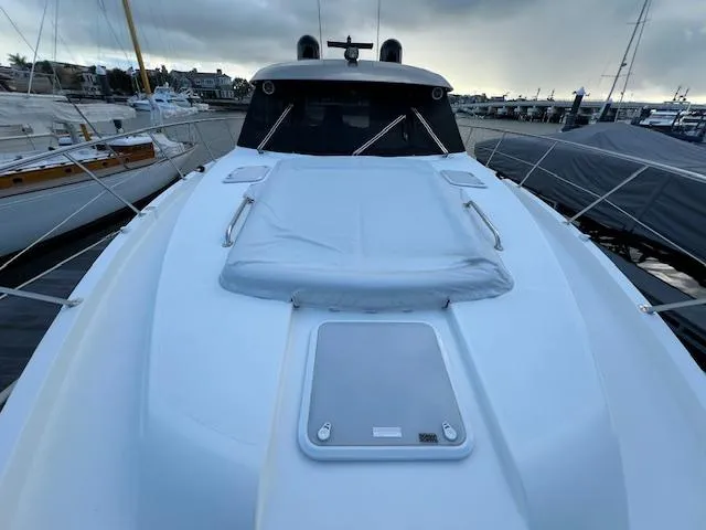 Slide: The Image of 2020 Riviera 5400 Sport Yacht docked, showcasing sleek design and spacious deck. - 13