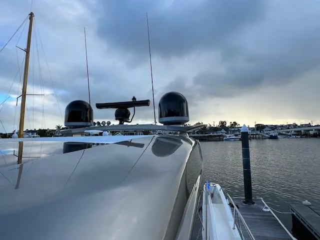 Slide: The Image of 2020 Riviera 5400 Sport Yacht docked under cloudy sky. - 17