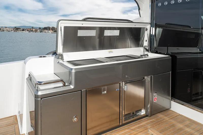Slide: The Image of Outdoor kitchen on 2020 Riviera 5400 Sport Yacht with stainless steel appliances. - 21