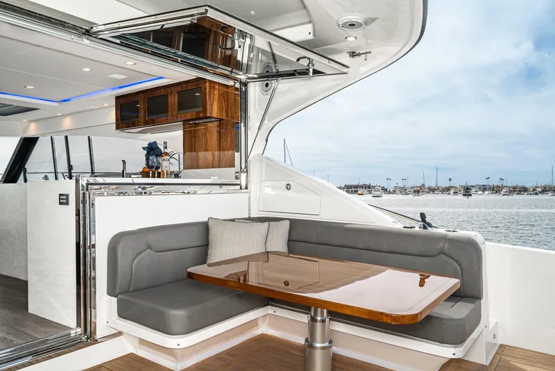 Slide: The Image of 2020 Riviera 5400 Sport Yacht with elegant outdoor seating and ocean view. - 24