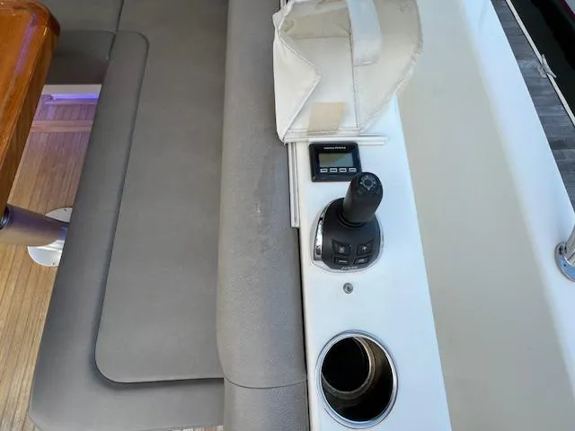 Slide: The Image of Riviera 5400 Sport Yacht 2020 interior with joystick control and cup holder. - 26