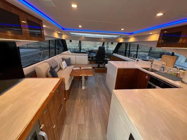 Slide: The Image of Luxurious interior of 2020 Riviera 5400 Sport Yacht with modern kitchen and seating area. - 27