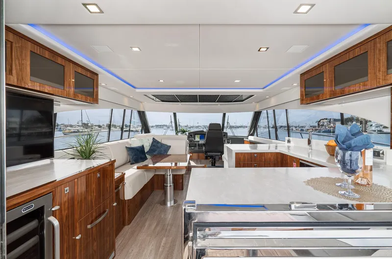 Slide: The Image of Luxurious interior of 2020 Riviera 5400 Sport Yacht with modern furnishings and panoramic windows. - 28