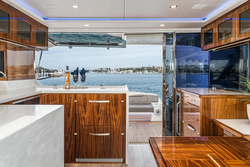 Slide: The Image of Riviera 5400 Sport Yacht 2020 interior with luxurious wood finish and ocean view. - 29