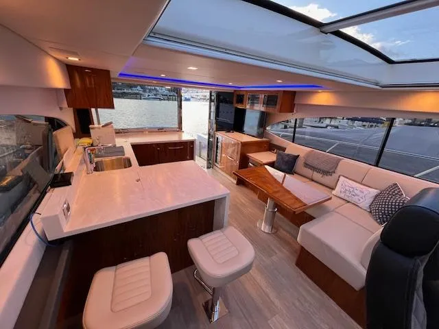 Slide: The Image of Luxurious interior of 2020 Riviera 5400 Sport Yacht with modern seating and panoramic windows. - 30