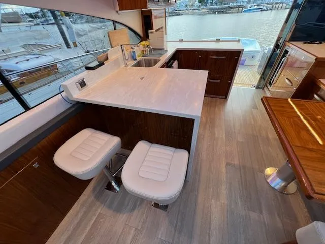 Slide: The Image of Luxurious interior of 2020 Riviera 5400 Sport Yacht with modern kitchen and seating area. - 31
