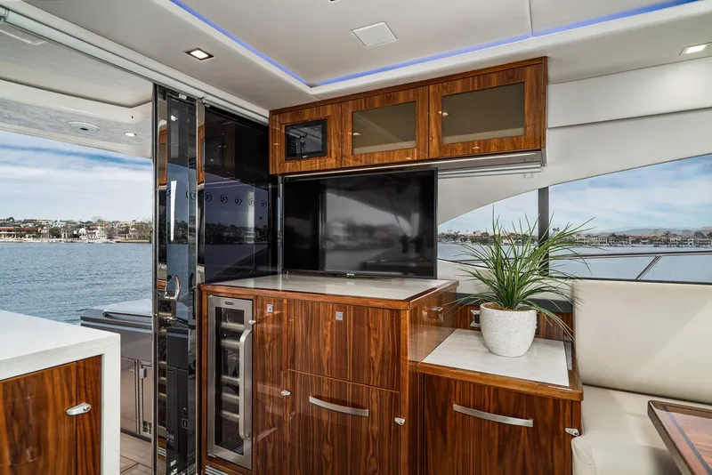 Slide: The Image of Luxurious interior of 2020 Riviera 5400 Sport Yacht with elegant wood cabinetry and scenic ocean view. - 32