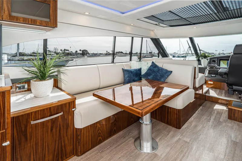 Slide: The Image of Luxurious interior of 2020 Riviera 5400 Sport Yacht with elegant seating and wooden table. - 36