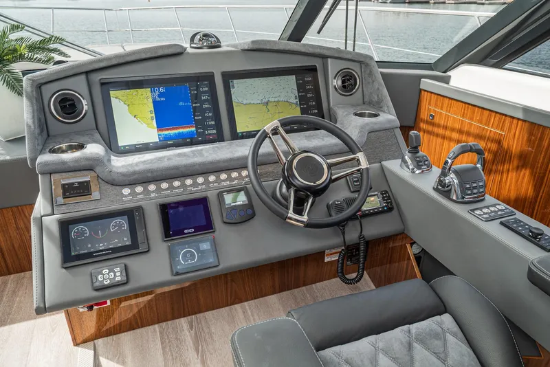 Slide: The Image of Helm of 2020 Riviera 5400 Sport Yacht with advanced navigation displays and controls. - 41
