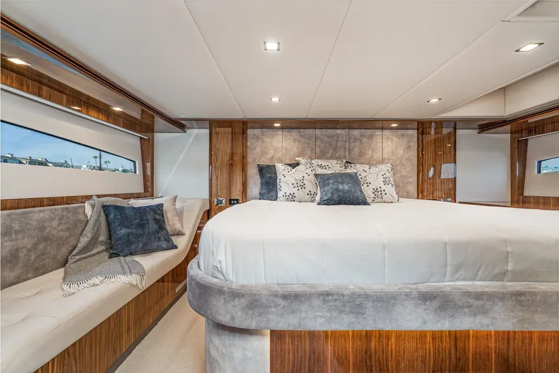 Slide: The Image of Luxurious bedroom interior of 2020 Riviera 5400 Sport Yacht with elegant wood finishes. - 47