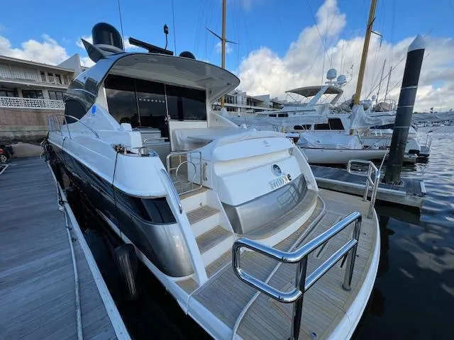 Slide: The Image of 2020 Riviera 5400 Sport Yacht docked at marina, showcasing sleek design and luxury features. - 8