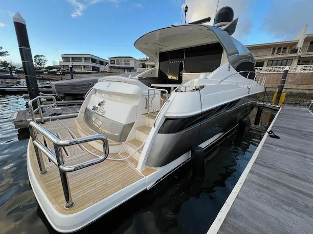 Slide: The Image of 2020 Riviera 5400 Sport Yacht docked at marina, showcasing sleek design and modern features. - 9