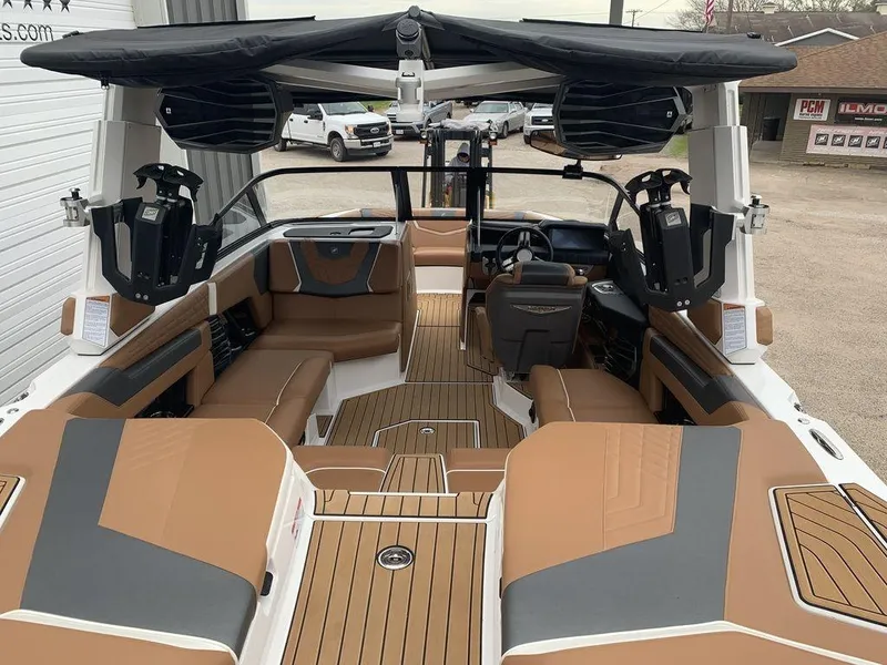 Slide: The Image of Interior of 2022 Nautique Super Air Nautique G21 boat with tan seating and modern design. - 2