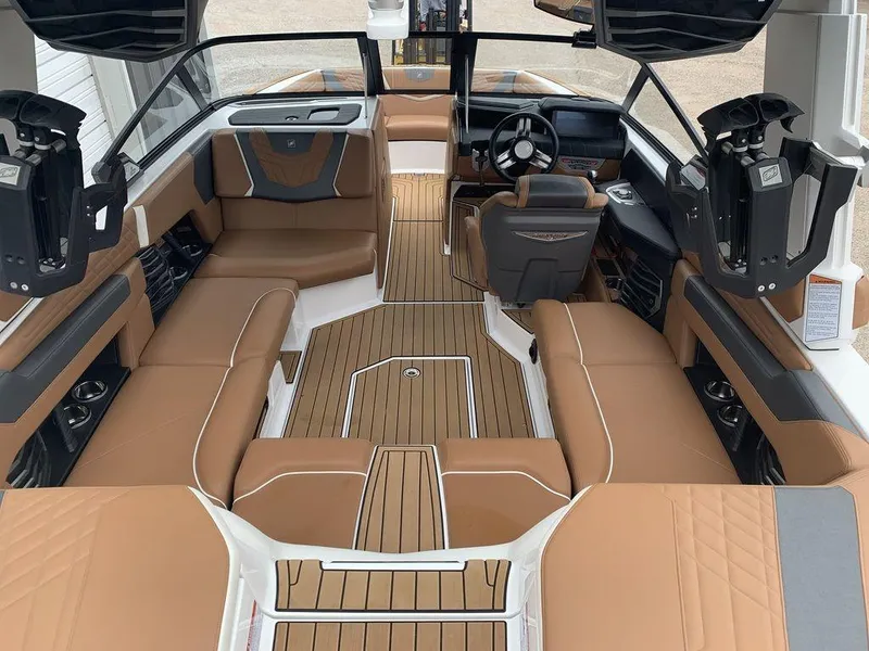 Slide: The Image of 2022 Nautique Super Air Nautique G21 interior with tan seating and sleek design. - 3
