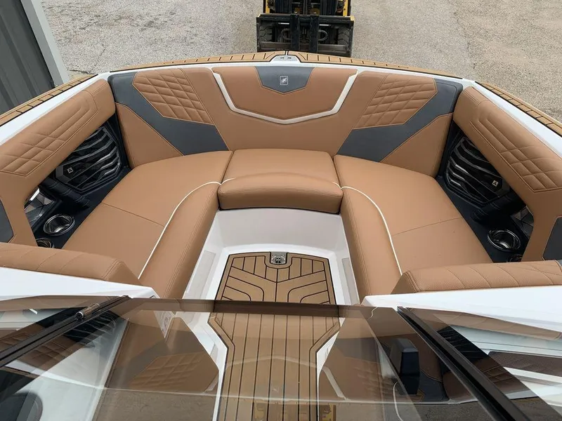 Slide: The Image of 2022 Nautique Super Air Nautique G21 boat interior with tan and gray seating. - 5